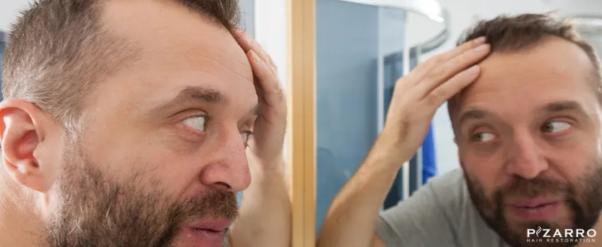 PHR - Man checking for hair loss signs in the mirror